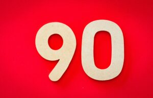 large number 90 on bright red background