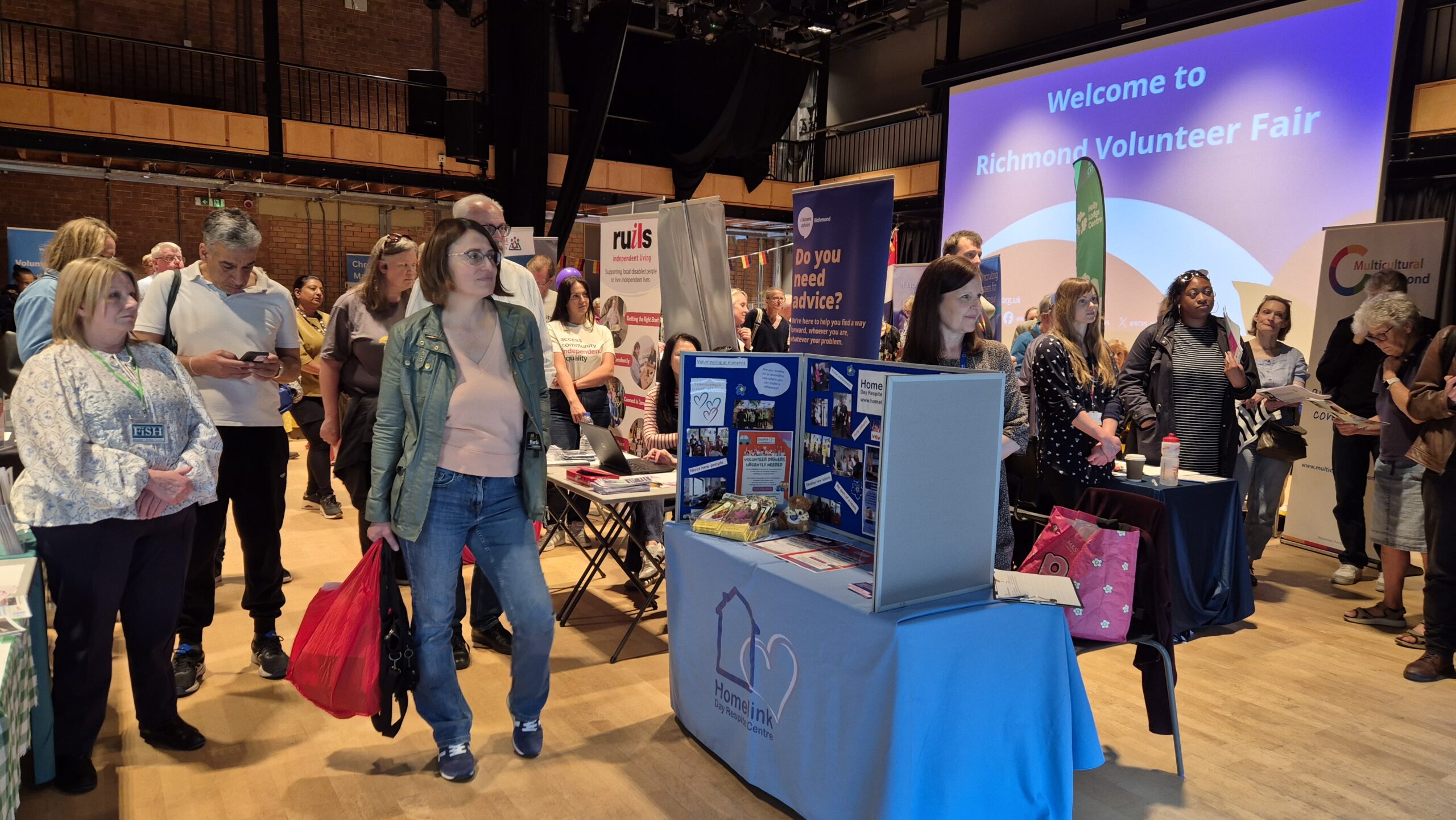 Stallholders and visitors in Theatre at Richmond Volunteer Fair 2026 during Mayor's opening speech