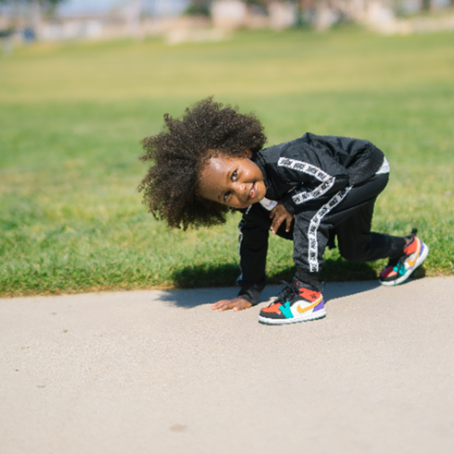 Boy in black tracksuit in park