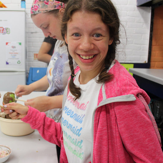 Girl in pink hoody cooking